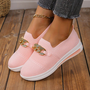 Pink mesh slip-on flats with chunky gold chain detail and white soles.