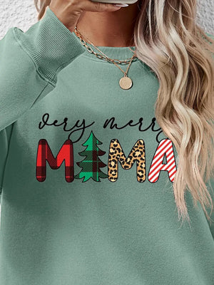 Sage green crewneck sweater with "Very Merry Mama" graphic featuring plaid, tree, leopard print, and stripes.