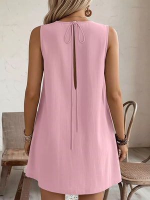 Blush pink sleeveless dress with back tie detail and open back.