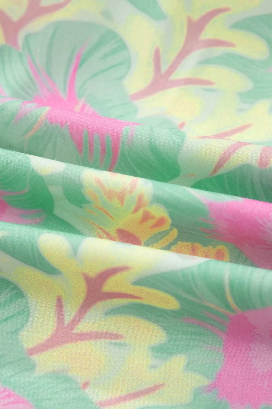 Pastel floral print polyester blouse with ruffled details and puff sleeves.