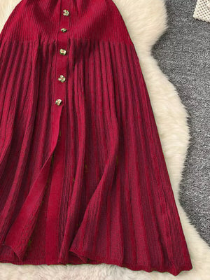 Red knit midi dress with vertical ribbing and gold button detail.