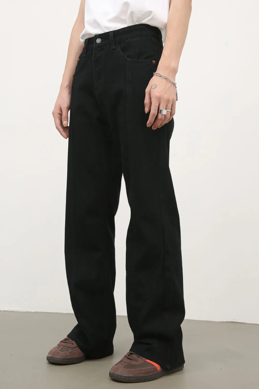 Black flare jeans with panel seams and a slight split hem detail.