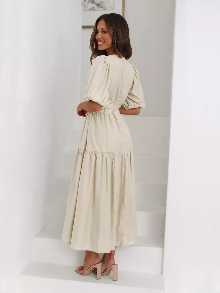 Beige puff sleeve midi dress with tiered skirt and cinched waist.