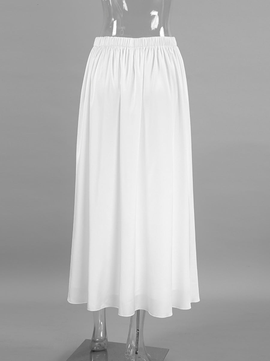 White high-waisted maxi skirt with elastic waistband and flowy silhouette.