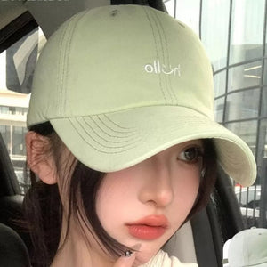 Light green cotton baseball cap with white embroidery detail