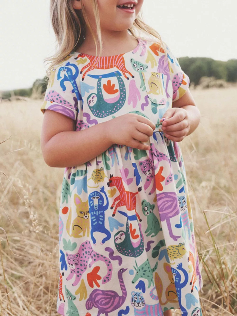 Toddler dress with playful animal print, short sleeves, and round neckline.
