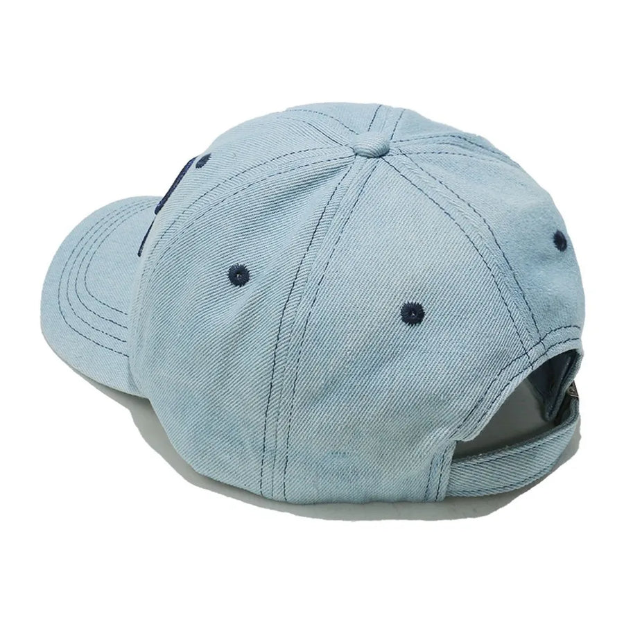 Light blue denim baseball cap with embroidered dark blue bow detail.