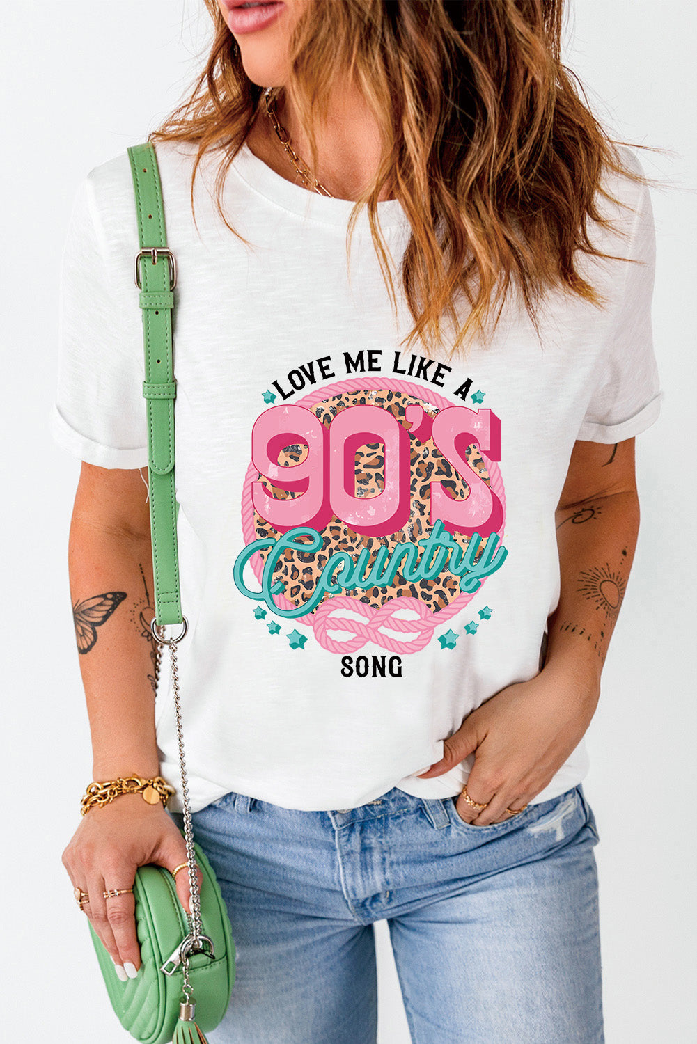 White graphic t-shirt with 90s country song design and leopard print.