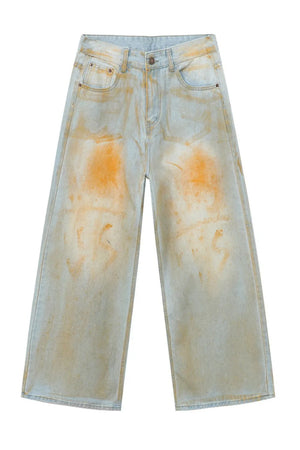 Acid wash palazzo denim jeans in light with orange splatters.
