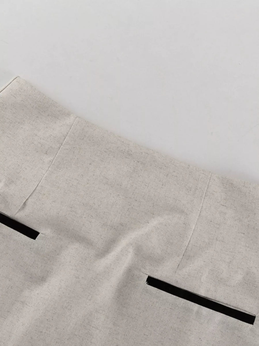 Light beige linen blend blazer with black trim pockets