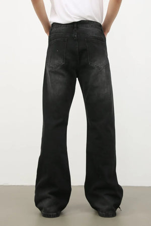 Dark wash denim trousers with exaggerated flare legs and a 70s style.