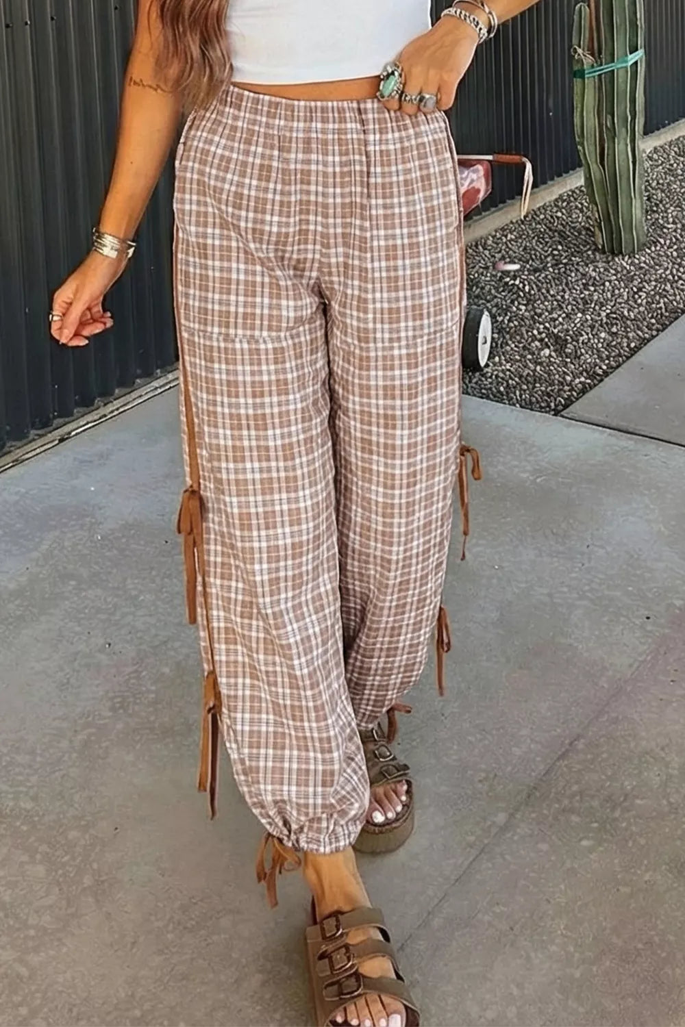 Plaid print casual pants with drawstring and tie details in camel and white.