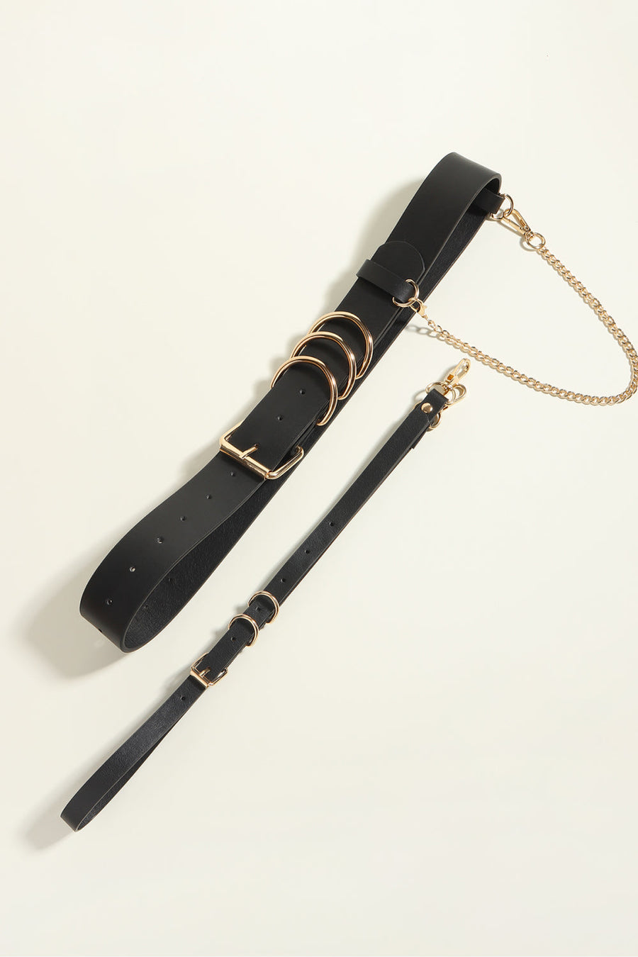 Black PU leather harness belt with gold chain detail and multiple rings