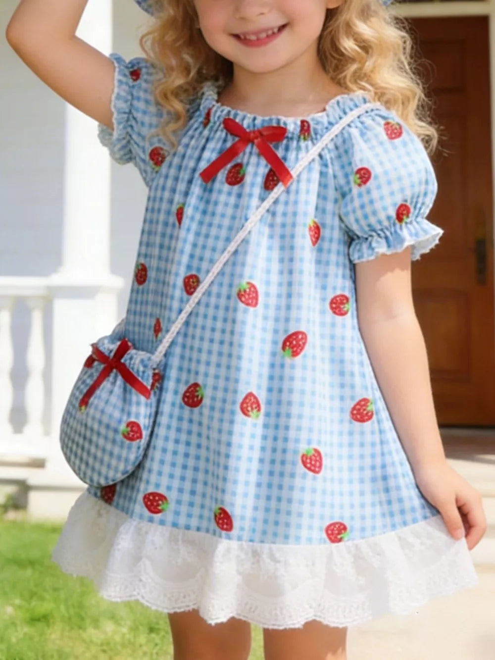 Baby dress set with blue gingham, strawberry print, puff sleeves, lace trim, and matching purse.
