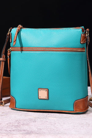 Turquoise leather crossbody bag with brown trim and brass zipper.