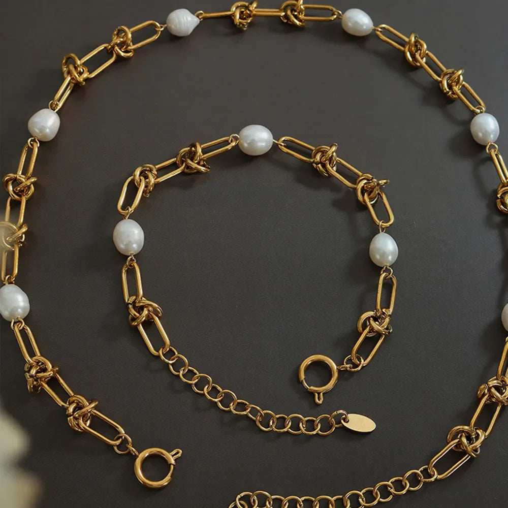 Gold linked pearl knot collar necklace with toggle clasp and extender chain.