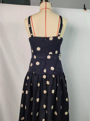 Navy polka dot midi dress with sweetheart neckline and belted waist.