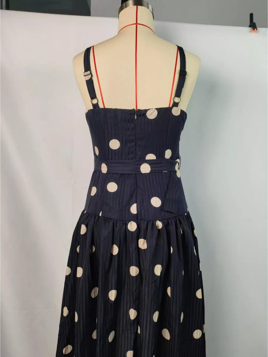 Navy polka dot midi dress with sweetheart neckline and belted waist.