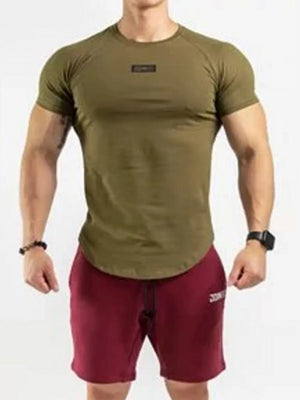 Olive performance raglan tee with black logo detail and curved hem.