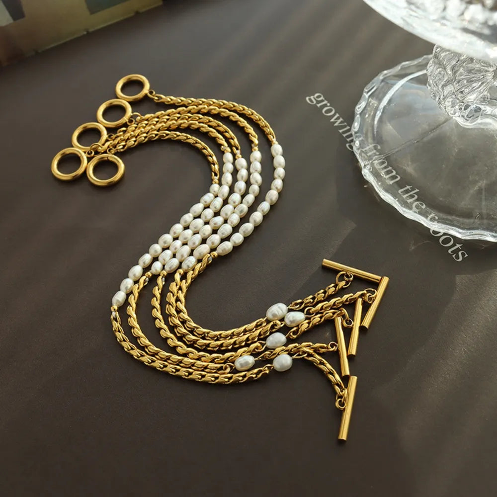 Gold cascading pearl and chain bracelet with toggle clasp