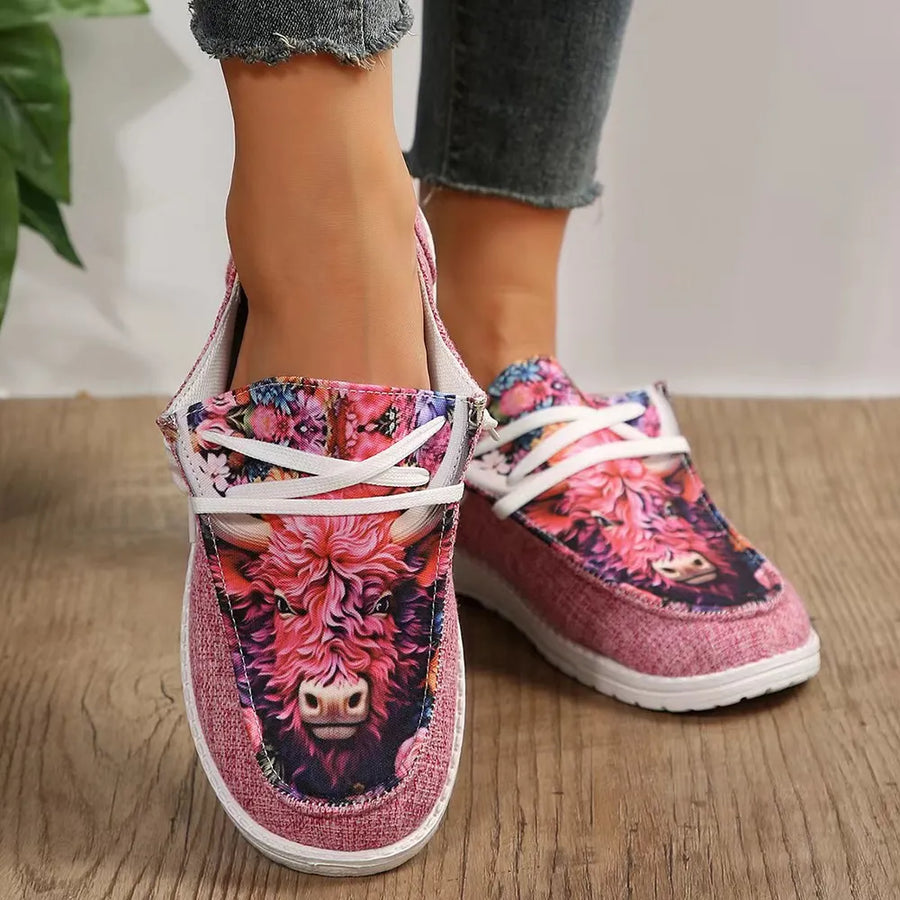 Pink canvas slip-on flats with bull head and floral print, white laces
