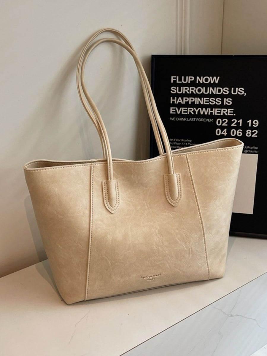 Off-white crinkled pu leather tote bag with twin straps and subtle embossed logo.