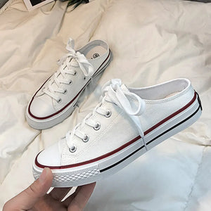 White canvas mule sneakers with contrast trim and laces