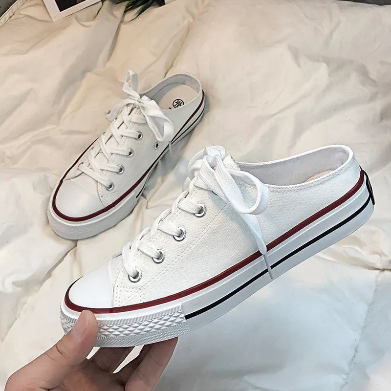 White canvas mule sneakers with contrast trim and laces