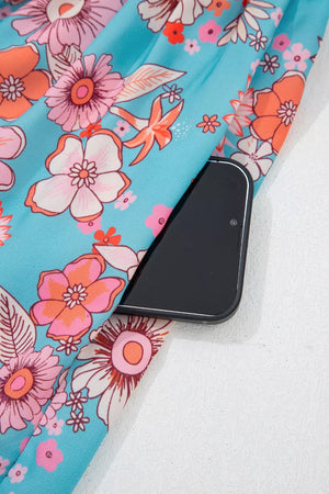 Maxi dress with vibrant floral print and side pocket detail.