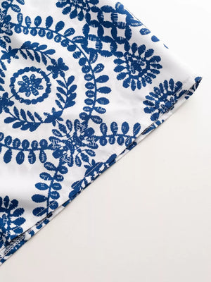 Blue and white printed romper detail, featuring a tie-waist and buttoned front.