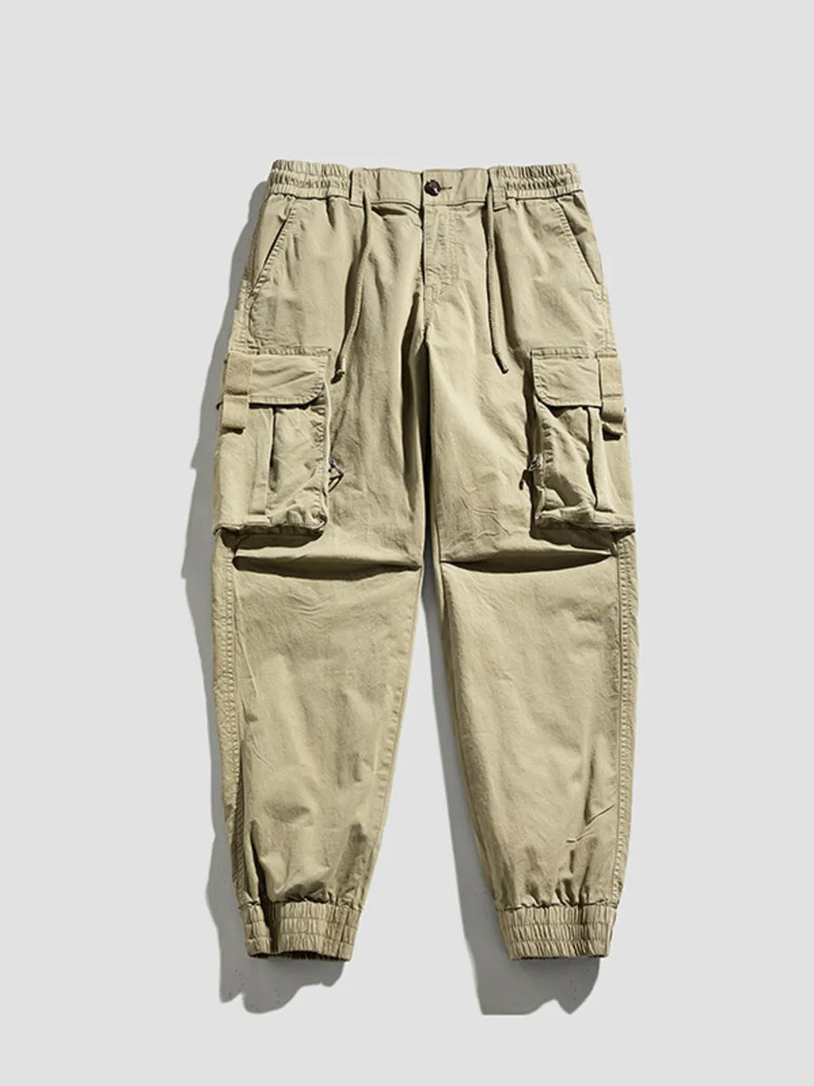 Khaki cargo joggers with flap pockets and elastic cuffs.