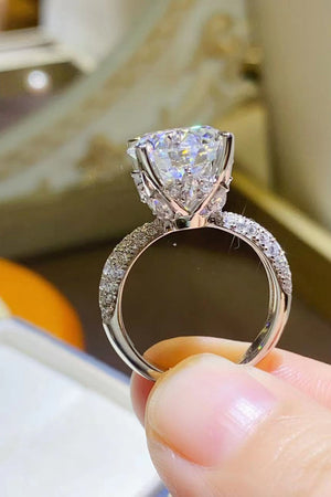 Silver pavé band round moissanite solitaire ring with a high setting.