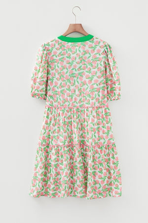 Women's tiered mini dress with puff sleeves, green neckline, and pink floral print.