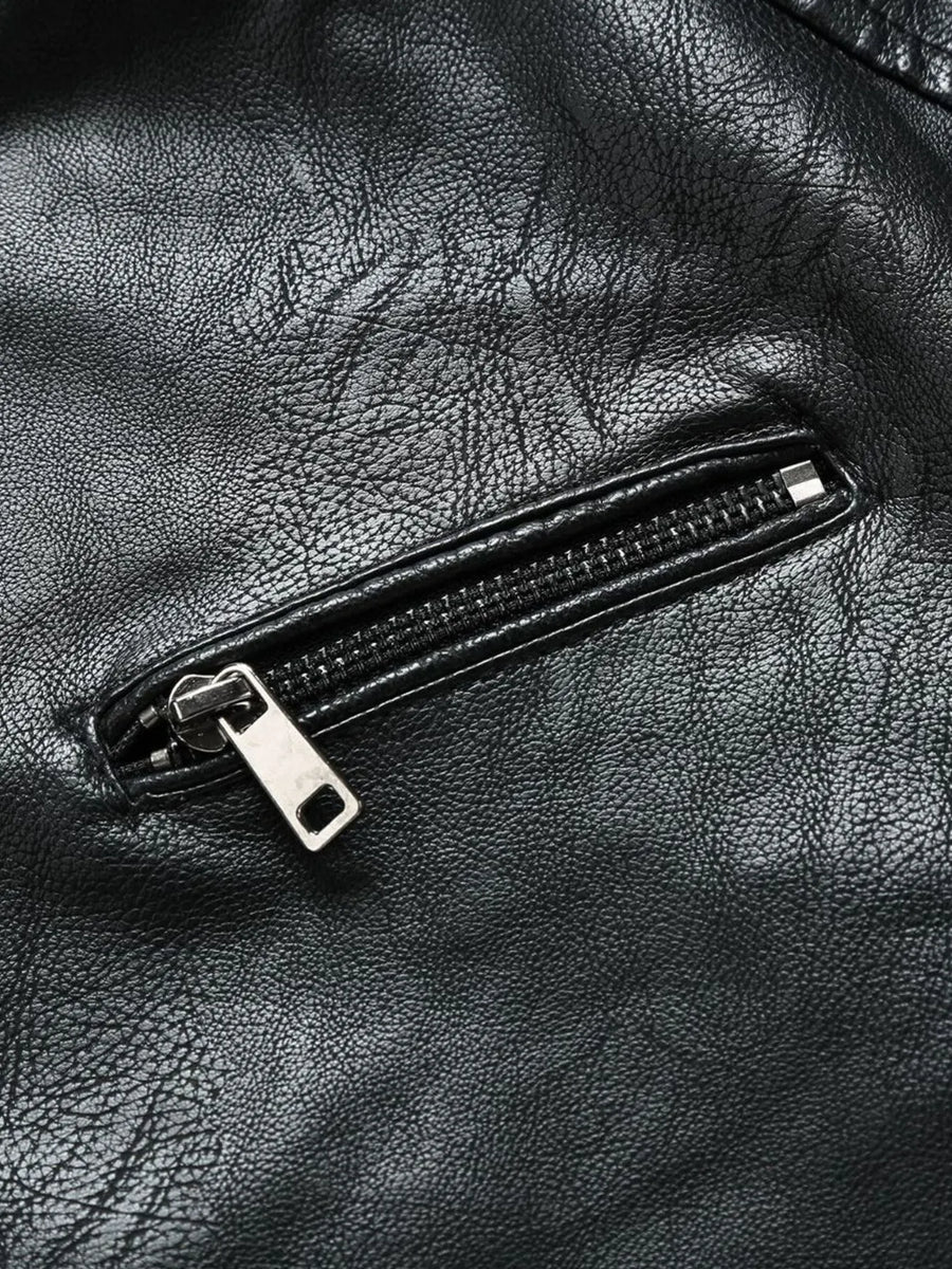 Black moto jacket detail showing a zippered pocket with silver hardware on faux leather.