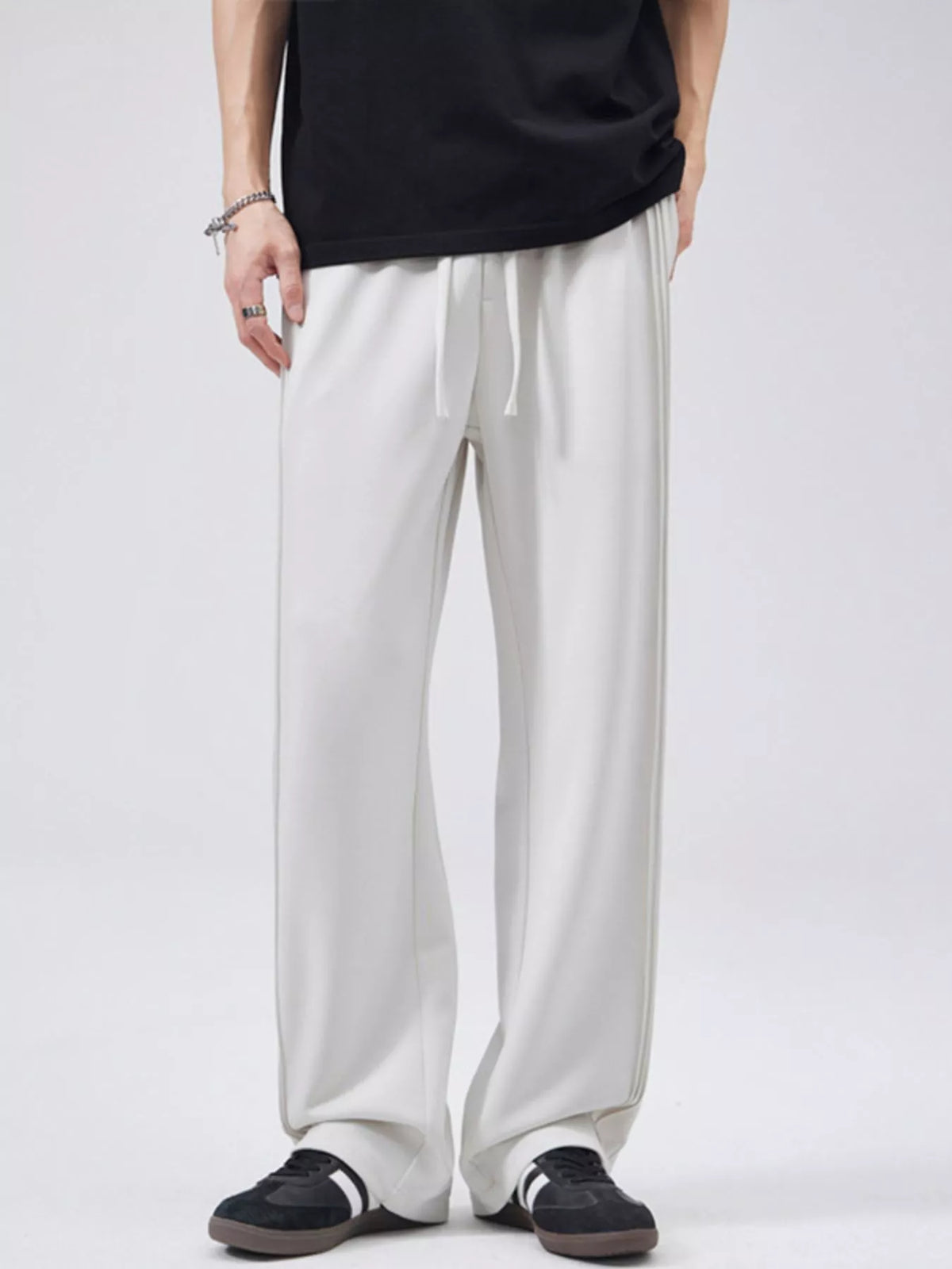 Relaxed fit light gray joggers with drawstring and subtle side stripe detail.