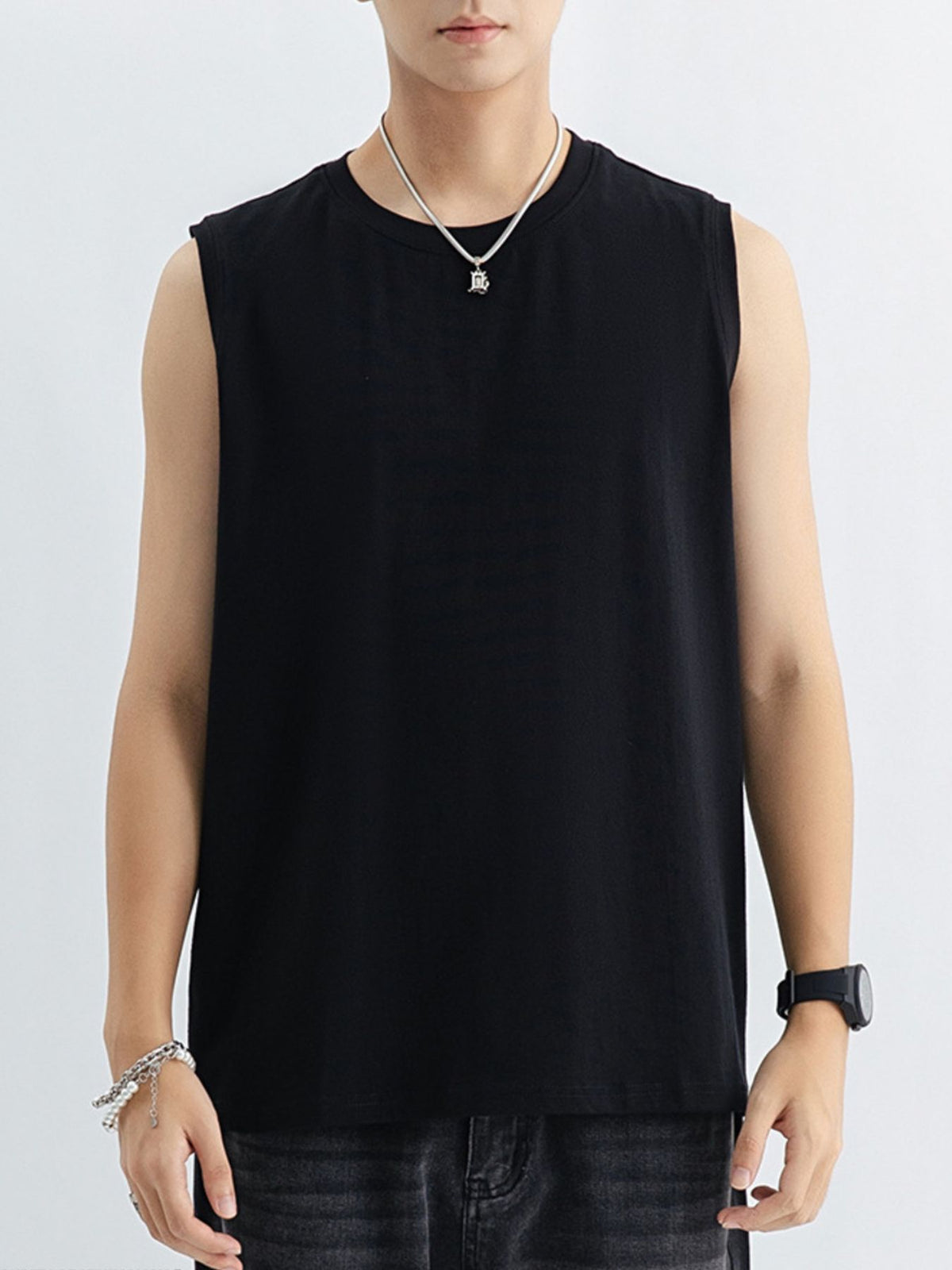 Men's black cotton tank top with a crew neck, sleeveless cut, and relaxed fit.