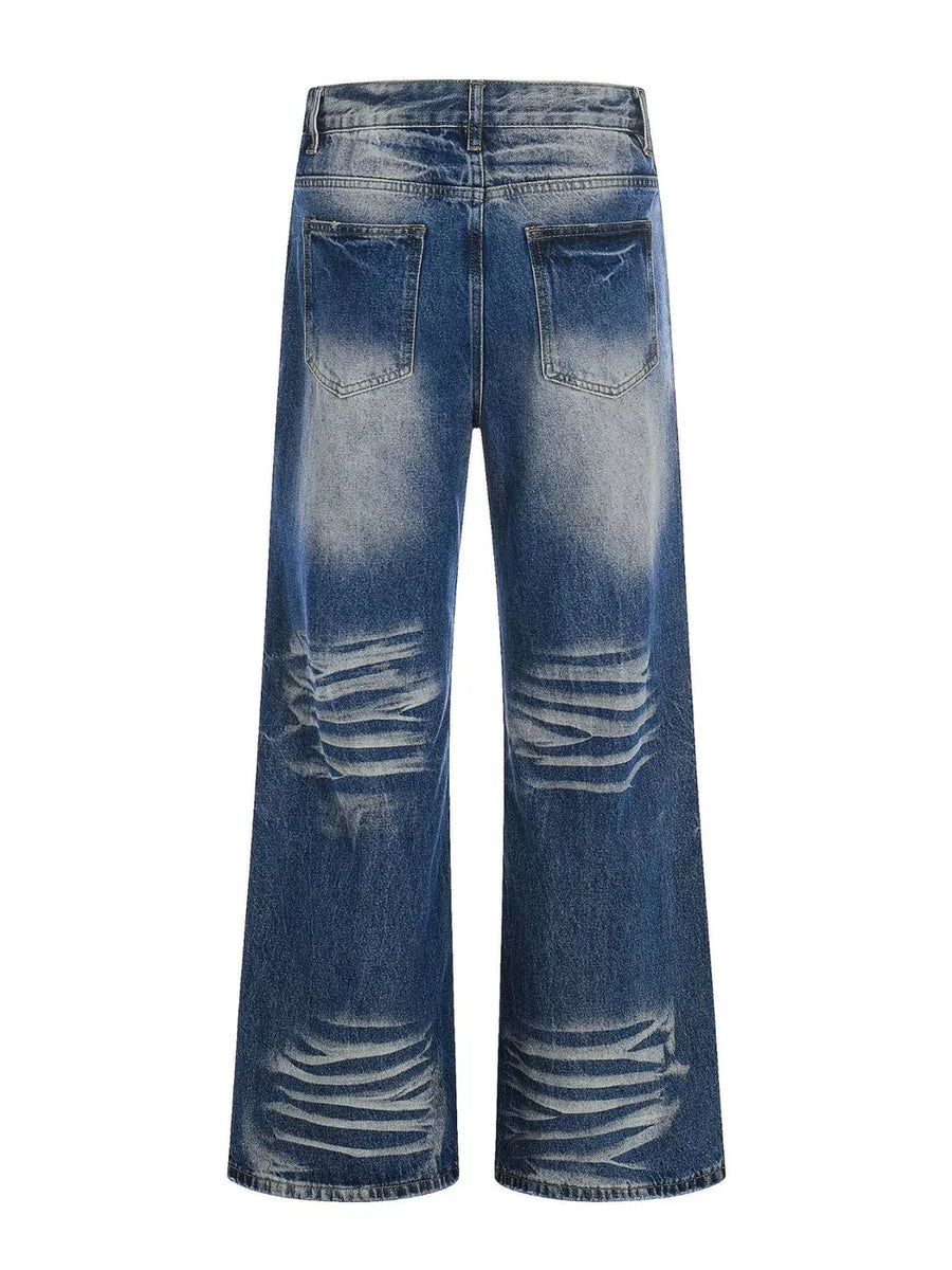 Men's light blue vintage wash wide leg jeans with distressed details