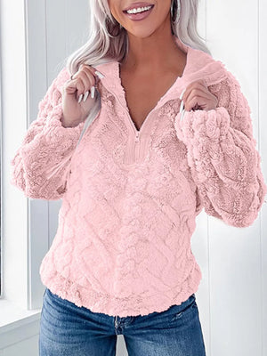 Pink textured fleece quarter zip sweatshirt with a plush, fuzzy finish and ribbed collar.