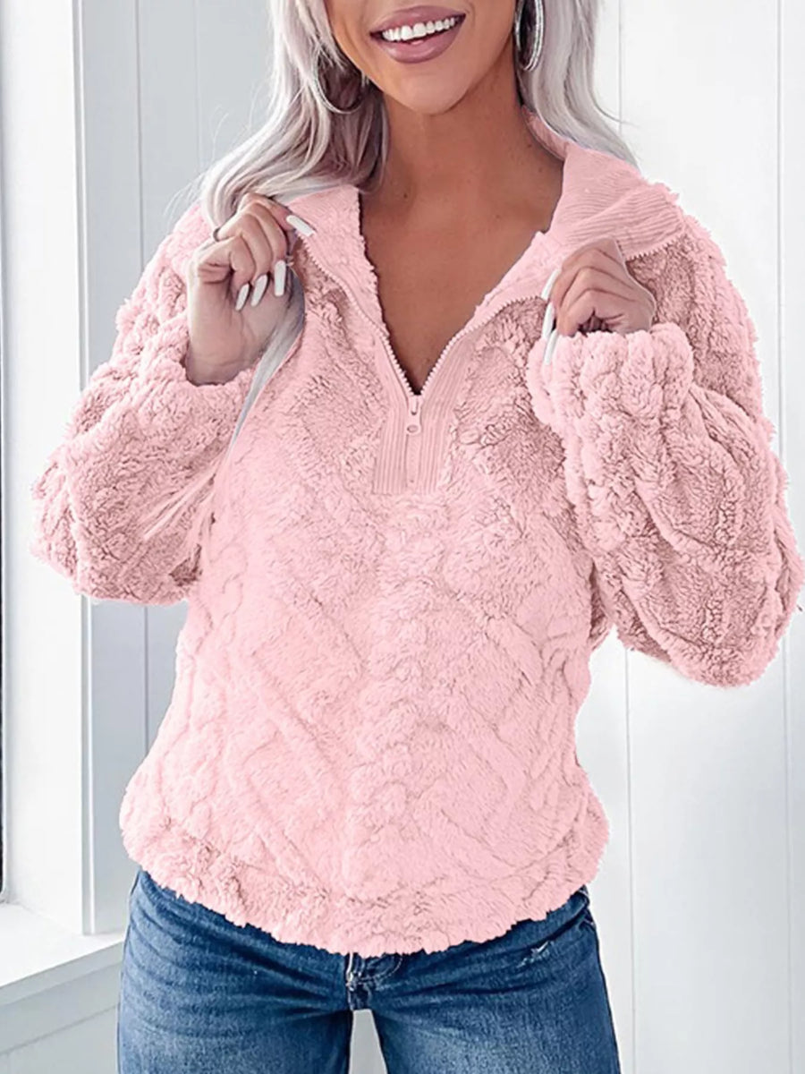 Pink textured fleece quarter zip sweatshirt with a plush, fuzzy finish and ribbed collar.