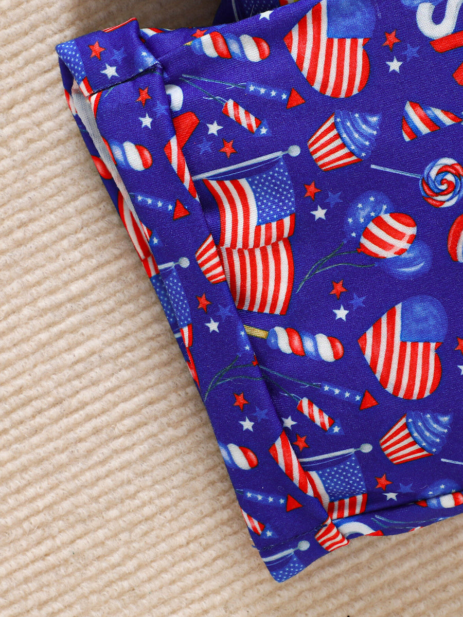 Baby patriotic shorts set with American flag and fireworks print on blue fabric.