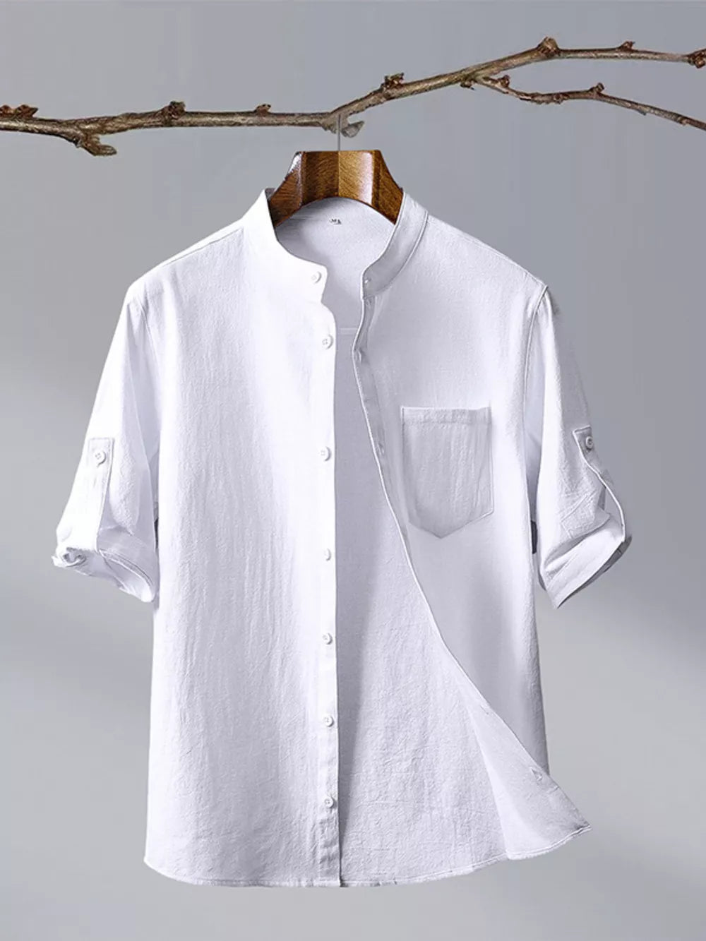 White cotton blend short sleeve shirt with mandarin collar and chest pocket.