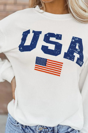 White ribbed knit sweatshirt with distressed blue USA graphic and American flag detail.