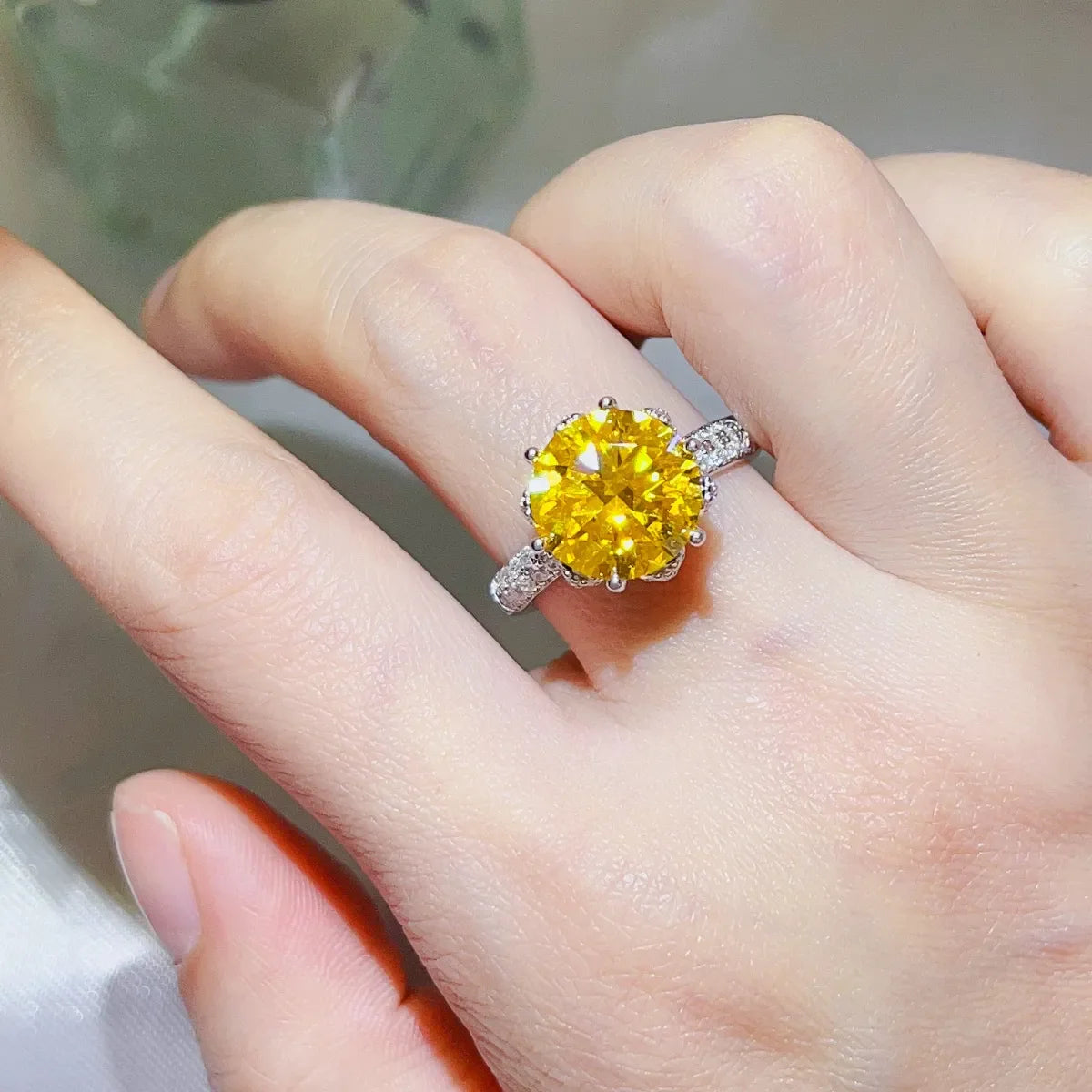 Radiant canary moissanite solitaire ring with diamond-accented band.