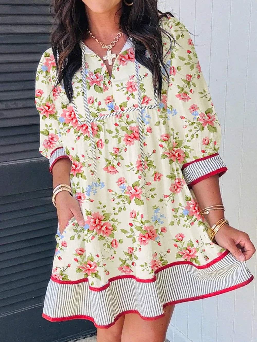 Floral pocketed puff sleeve dress with tie neck and striped trim