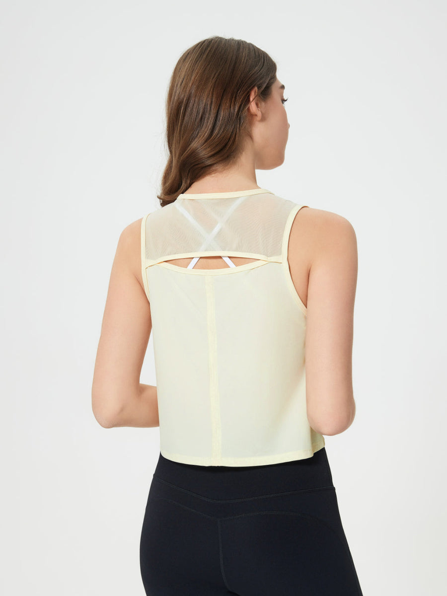 Pastel Yellow cropped active tank with mesh back detail and white bra straps visible.