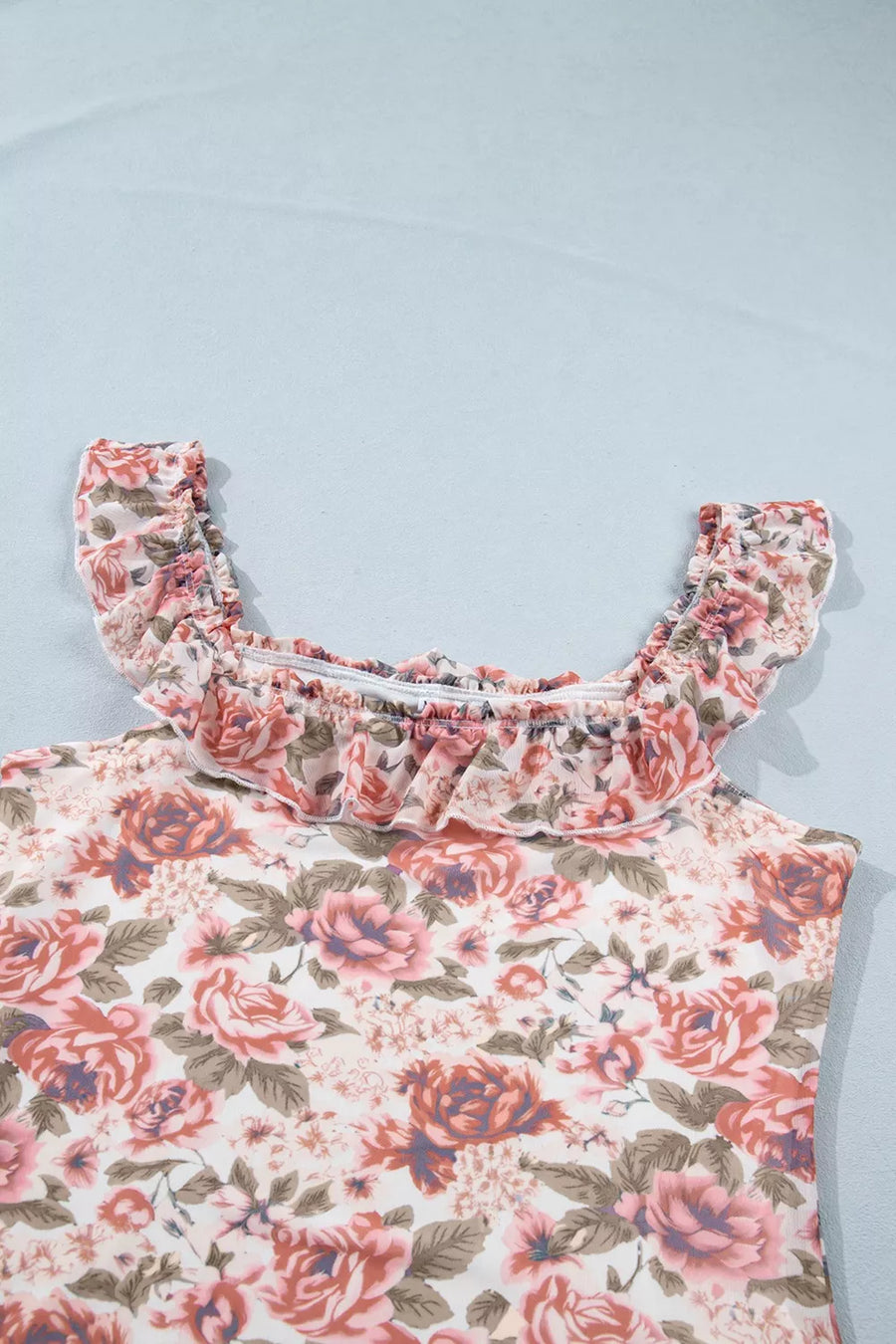 Floral ruffle-trimmed tank top in polyester with a vintage rose print and smocked neckline.