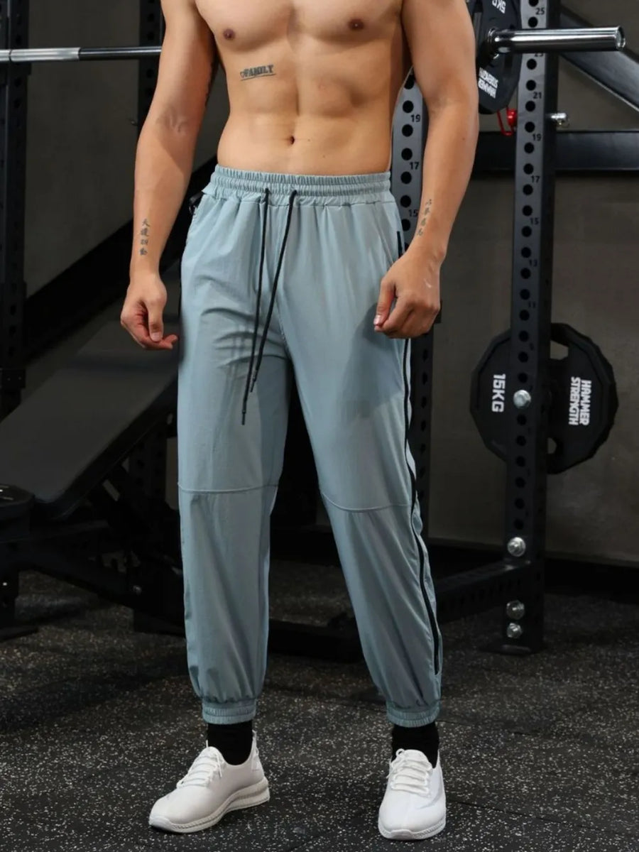 Air Force Blue track pants with drawstring waist and zip detail on side seam