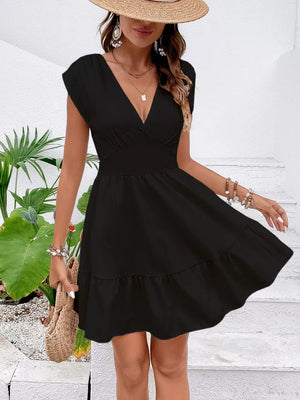 Black cap sleeve mini dress with tiered ruffle hem and deep V-neckline.