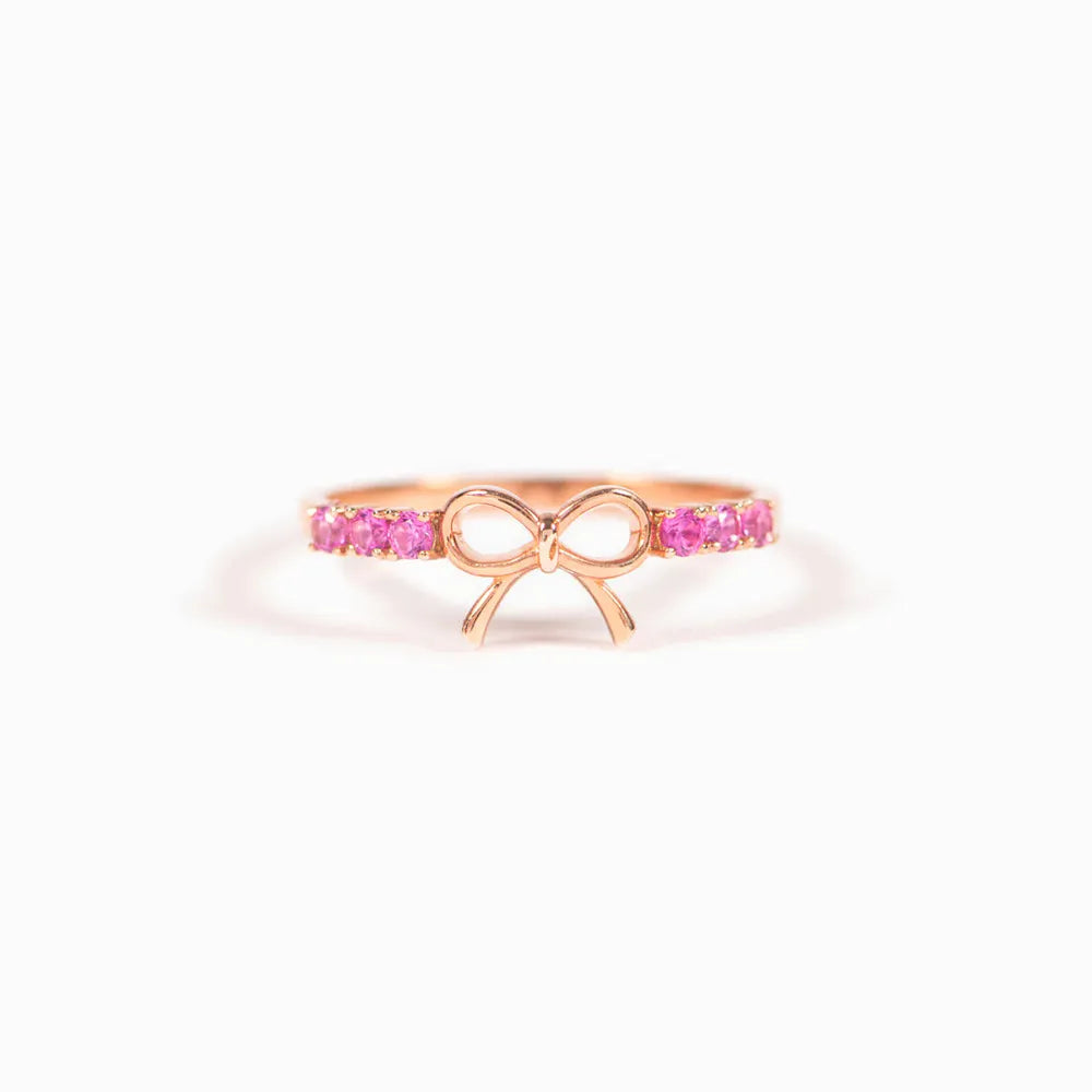 Rose gold ring with a bow design and pink gemstones
