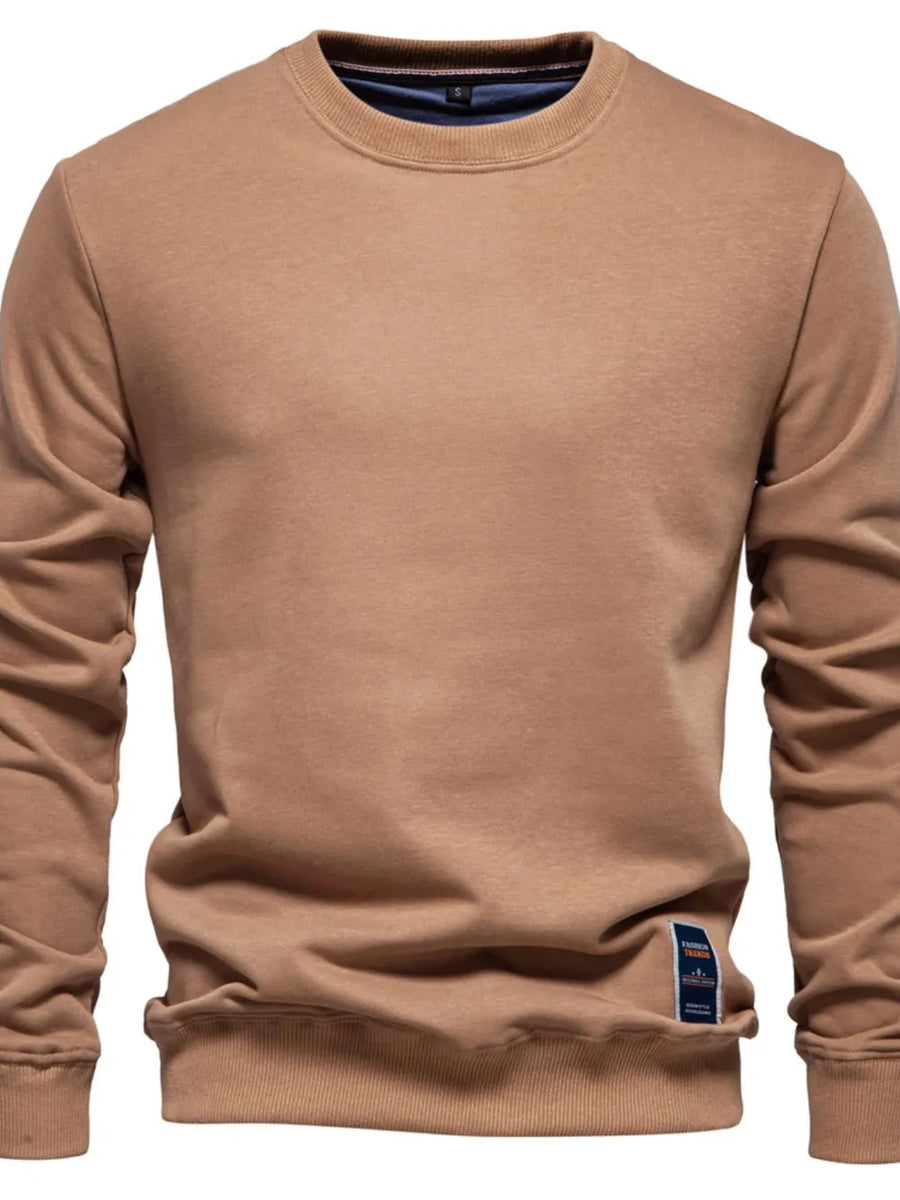 Camel crewneck sweatshirt with subtle patch detail on the hem